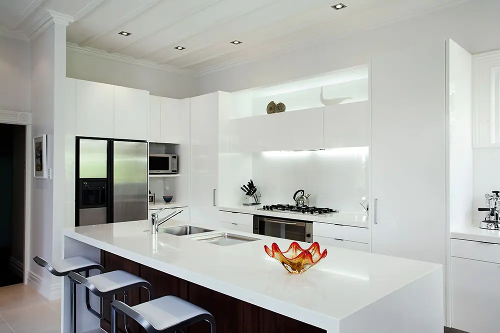 Modern Auckland kitchen renovation with white joinery and integrated appliances