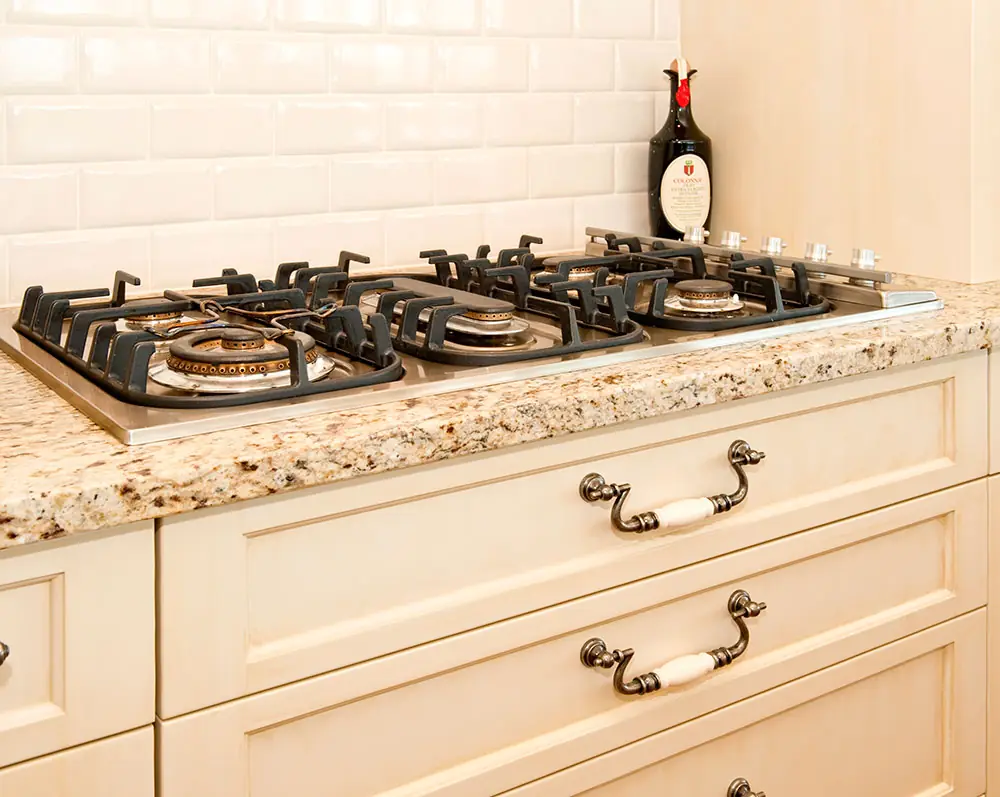 Traditional Auckland kitchen renovation with a granite benchtop and five-burner gas cooktop