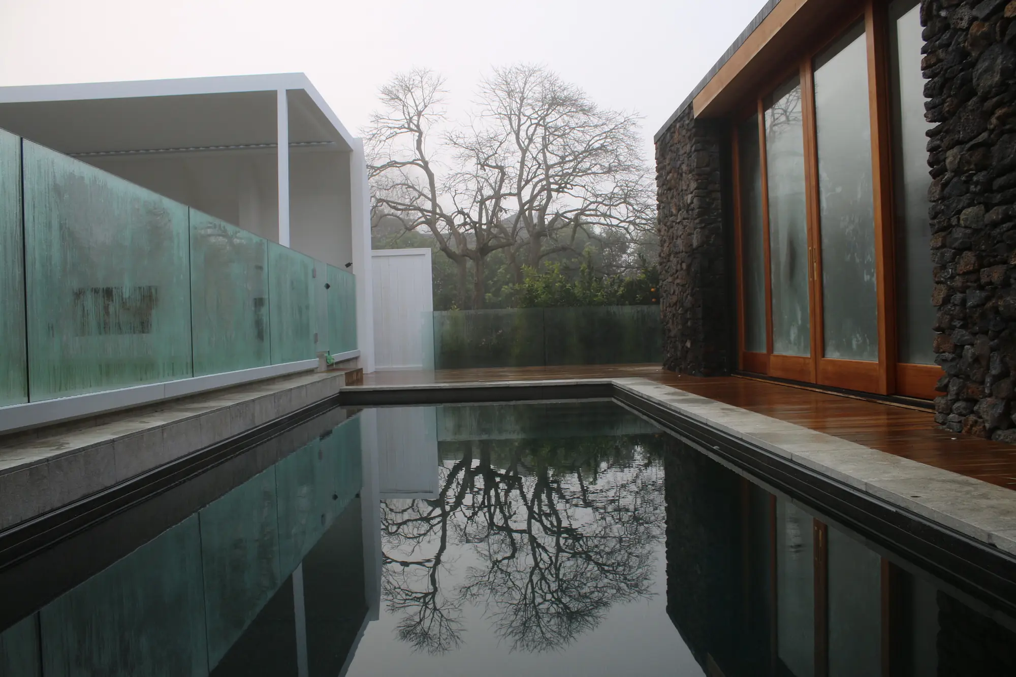 Pool, stone pool house and hardwood deck at a restored Mt Eden villa