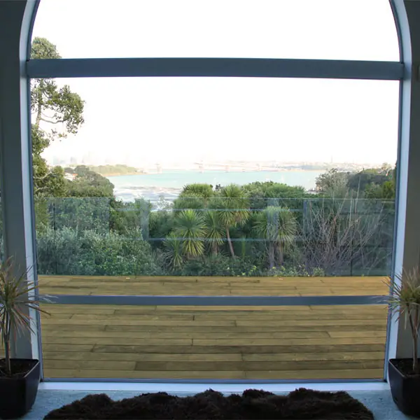 Arched window framing the harbour view at Northcote Point