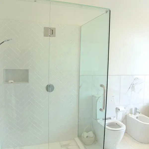 Remuera bathroom after renovation with a frameless glass shower and herringbone tiles