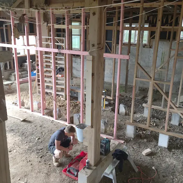 New framing going in among the piles under a Remuera bungalow during the basement conversion