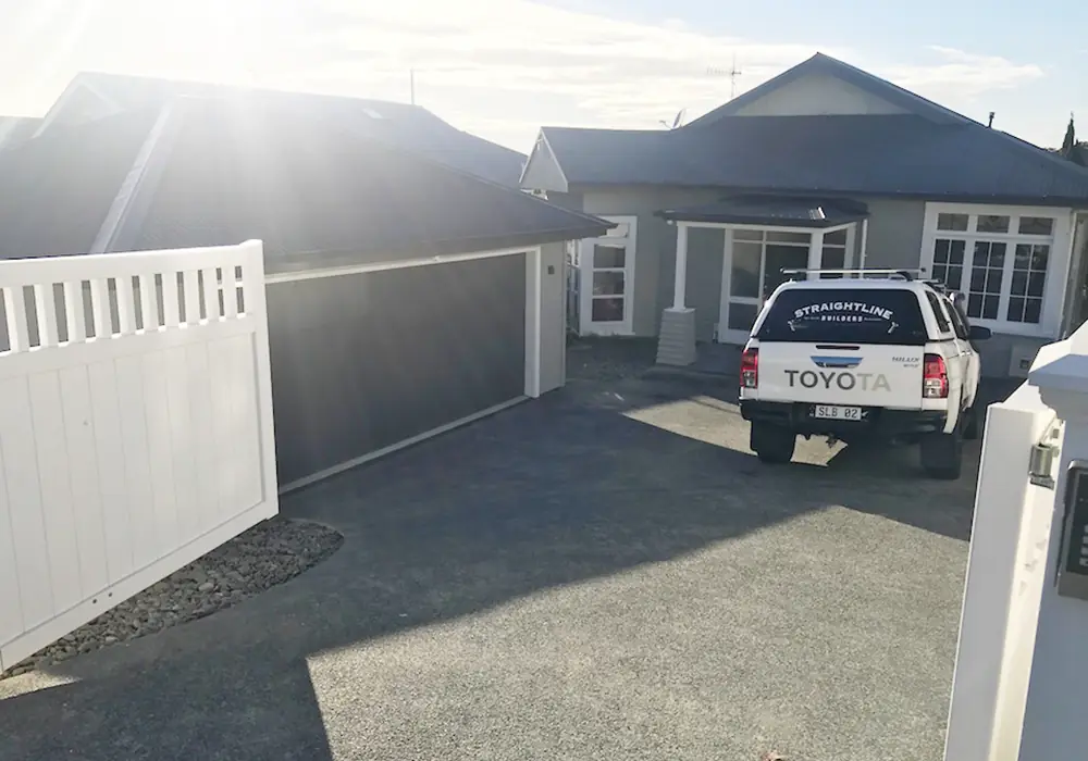 Front of the renovated Remuera bungalow with the Straightline Builders ute in the drive