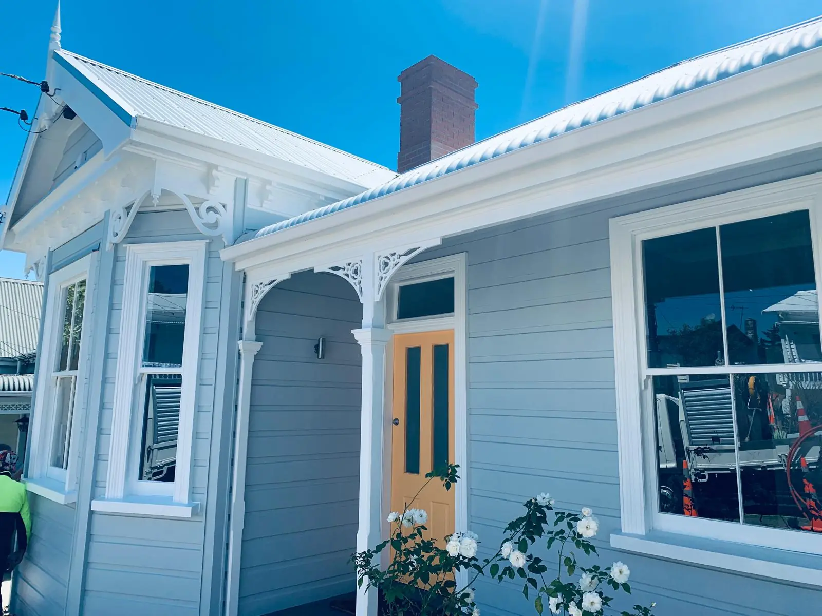 Restored Auckland villa with new fretwork, sash windows and a yellow front door
