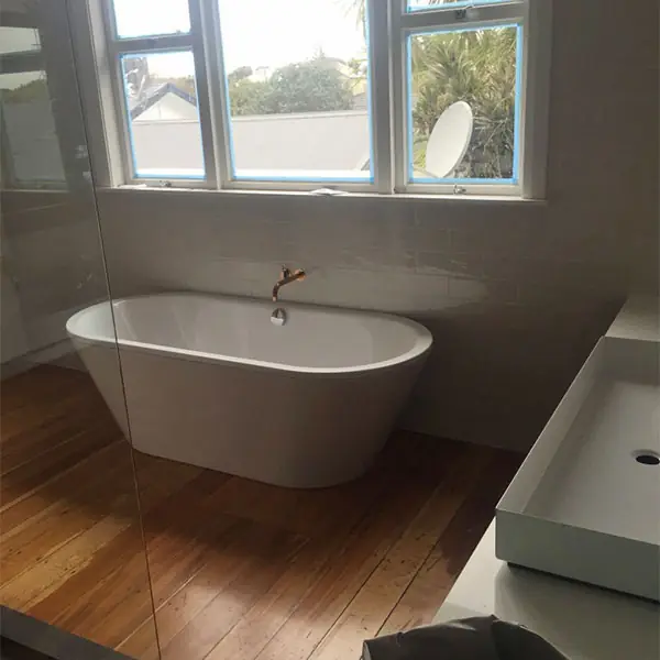 Western Springs bathroom after renovation with a freestanding bath and timber floor